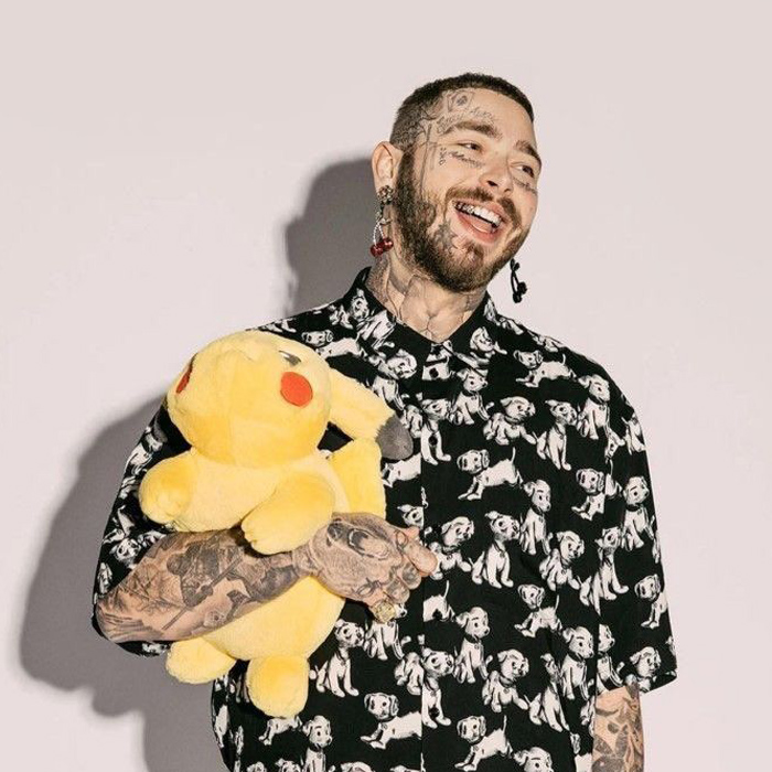 white man named postmalone laughing with a teddy bear in his hand