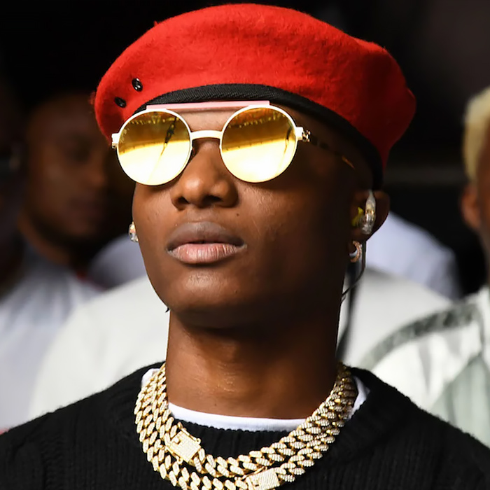 black man named wizkid with red cap and golden sunglasses